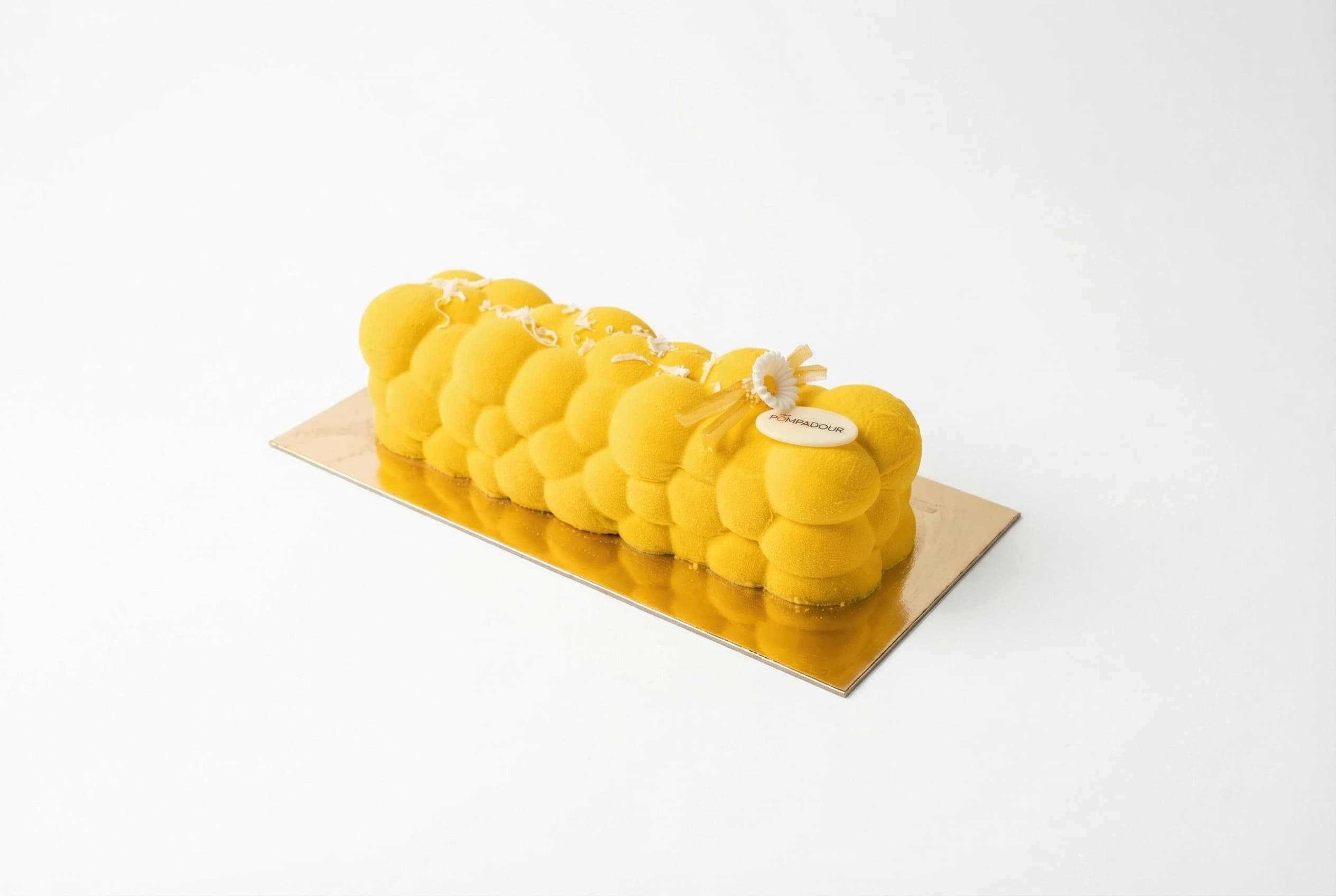 Yellow Lemon Coconut Log — Light vanilla sponge layered with airy lemon mousse, coconut, and bright lemon zest filling.