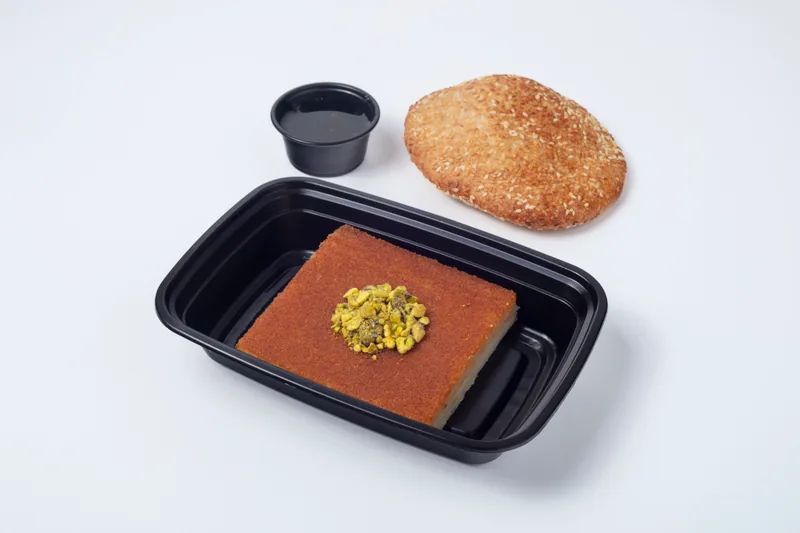 Kanafeh — Experience Beverly Hills' finest Kanafeh. Stretchy melted cheese beneath a golden, crispy phyllo crust, served with traditional sesame bread and simple syrup. Best enjoyed warm. We also offer a large Kanafeh tray perfect for Ramadan gatherings. Please inquire for details.